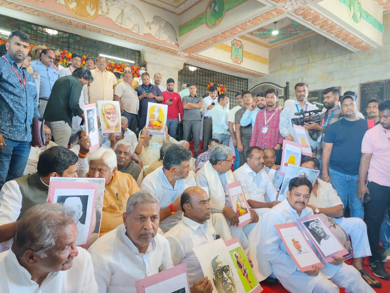 The Congress led by Leader of Opposition in the Assembly Siddaramaiah and party's state President D K Shivakumar staged a demonstration outside 'Suvarna Vidhana Soudha' holding pictures of several national and state icons like Kuvempu, Narayana Guru, Shishunala Sharif, Pandit Jwaharlal Nehru, Babu Jagjivan Ram among others (Pic/Official Twitter handle of Karnataka Congress)